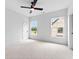 Bright bedroom featuring vaulted ceiling, ceiling fan, and large windows with outdoor views at 206 Regester Way, Peachtree City, GA 30269
