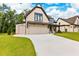Beautiful home exterior featuring a spacious driveway, two-car garage, and a well-manicured lawn at 206 Regester Way, Peachtree City, GA 30269