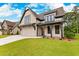 Stunning exterior of a two story home showcasing a manicured lawn, neutral colors and stylish architectural details at 206 Regester Way, Peachtree City, GA 30269