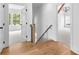 Hallway with wood floors, white walls, and natural light coming from windows at 206 Regester Way, Peachtree City, GA 30269