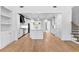 Open-concept kitchen with white cabinets, large island, stainless steel appliances, and hardwood floors at 206 Regester Way, Peachtree City, GA 30269
