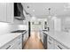 Bright kitchen features white cabinets, stainless appliances, and a herringbone tile backsplash at 206 Regester Way, Peachtree City, GA 30269