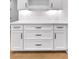 The kitchenette showcases white cabinets, bronze hardware, and herringbone backsplash tiles at 206 Regester Way, Peachtree City, GA 30269