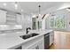 An open kitchen showcases a large island with seating, stainless steel appliances, and natural light at 206 Regester Way, Peachtree City, GA 30269