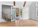 Bright living room with hardwood floors, white walls, wood beams and access to outdoor space at 206 Regester Way, Peachtree City, GA 30269