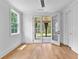 Bright living area with hardwood floors and access to outdoor living space through glass doors at 206 Regester Way, Peachtree City, GA 30269