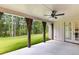 Covered back patio featuring rustic wood columns, ceiling fan and view of the private backyard at 206 Regester Way, Peachtree City, GA 30269