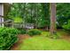 A lush backyard with a small bridge leading to an additional structure at 3549 Dogwood Dr, Powder Springs, GA 30127