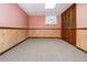 View of partially finished basement with paneled walls and closet at 3549 Dogwood Dr, Powder Springs, GA 30127