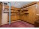 Basement area featuring wood paneled walls, ample shelving, and a utility closet at 3549 Dogwood Dr, Powder Springs, GA 30127