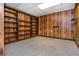 Finished basement area with wall to wall wood shelves and light gray carpeting at 3549 Dogwood Dr, Powder Springs, GA 30127