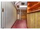 Hallway of a finished basement with striped wallpaper, utility access, and storage at 3549 Dogwood Dr, Powder Springs, GA 30127