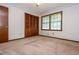 Bedroom with carpet, natural light from two windows, and closet with wood doors at 3549 Dogwood Dr, Powder Springs, GA 30127