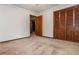 Spacious carpeted bedroom with wood closet doors at 3549 Dogwood Dr, Powder Springs, GA 30127