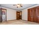 Bedroom featuring a ceiling fan, neutral carpet, and wood closet doors at 3549 Dogwood Dr, Powder Springs, GA 30127