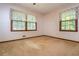 Cozy bedroom with carpet, two windows and neutral walls at 3549 Dogwood Dr, Powder Springs, GA 30127