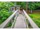 Wooden bridge in the backyard that leads to a backyard addition at 3549 Dogwood Dr, Powder Springs, GA 30127