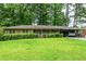 Charming one-story brick home featuring a lush lawn and a convenient attached carport at 3549 Dogwood Dr, Powder Springs, GA 30127