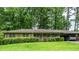 Charming brick home with a well-manicured lawn, mature trees, and a convenient carport at 3549 Dogwood Dr, Powder Springs, GA 30127