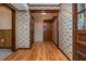 Welcoming hallway featuring floral wallpaper, wood trim, and hardwood floors for an inviting transition space at 3549 Dogwood Dr, Powder Springs, GA 30127