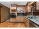 Well-lit kitchen featuring granite countertops, stainless steel appliances, and wood cabinetry at 3549 Dogwood Dr, Powder Springs, GA 30127