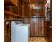 Functional laundry room featuring wood cabinetry, linoleum flooring, and a washing machine for household convenience at 3549 Dogwood Dr, Powder Springs, GA 30127