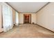 Spacious living room with plush carpet, classic wallpaper border, and ample natural light at 3549 Dogwood Dr, Powder Springs, GA 30127