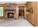 Inviting living room showcasing a brick fireplace, wood paneling, and an open layout perfect for entertaining at 3549 Dogwood Dr, Powder Springs, GA 30127