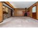 Expansive living area featuring wood paneling, a wood-burning stove, and access to the outdoors for comfortable living at 3549 Dogwood Dr, Powder Springs, GA 30127