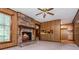 Charming living room with brick fireplace, wood paneling, and view of the kitchen for easy entertaining and Gathering living at 3549 Dogwood Dr, Powder Springs, GA 30127