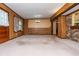 Large living area boasts wood paneling, natural light, and access to other rooms for a seamless living experience at 3549 Dogwood Dr, Powder Springs, GA 30127