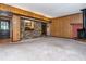Bright living area boasts wood paneling, a wood-burning stove, and access to the outdoors for comfortable living at 3549 Dogwood Dr, Powder Springs, GA 30127
