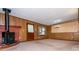 Spacious living area featuring a wood-burning stove, wood paneling, and ample space for relaxation and gatherings at 3549 Dogwood Dr, Powder Springs, GA 30127