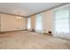 Spacious living room with plush carpet, classic wallpaper border, and ample natural light at 3549 Dogwood Dr, Powder Springs, GA 30127