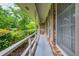 Covered porch with white railing, brick accents, and view of landscaped yard with mature trees at 3549 Dogwood Dr, Powder Springs, GA 30127