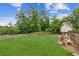 Spacious backyard features lush green lawn, mature trees, and fenced perimeter at 840 Yosemite Dr, Suwanee, GA 30024