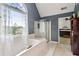 Bathroom featuring a soaking tub with a large arched window and separate shower at 840 Yosemite Dr, Suwanee, GA 30024