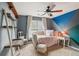 Stylish bedroom with a unique accent wall, a comfortable daybed, and creative decor at 840 Yosemite Dr, Suwanee, GA 30024