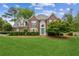 Charming two-story brick home with a well-manicured lawn and a bright blue front door at 840 Yosemite Dr, Suwanee, GA 30024