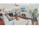 Cozy living room with a fireplace, a ceiling fan, and lots of natural light at 840 Yosemite Dr, Suwanee, GA 30024