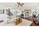 Bright open-concept living room featuring hardwood floors and a ceiling fan at 840 Yosemite Dr, Suwanee, GA 30024