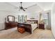 Spacious primary bedroom featuring a tray ceiling, ceiling fan, and complete furniture set at 840 Yosemite Dr, Suwanee, GA 30024