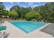 Community pool surrounded by trees and lounge chairs at 840 Yosemite Dr, Suwanee, GA 30024