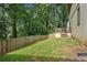 Landscaped backyard features a wooden fence, green grass, and a small deck, providing a private outdoor space at 2156 Doris Dr, Decatur, GA 30034