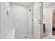 Walk-in shower with white tile and a built-in bench at 2156 Doris Dr, Decatur, GA 30034
