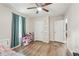 Bedroom featuring wood-look floors, a ceiling fan, and storage shelves at 2156 Doris Dr, Decatur, GA 30034