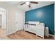 Bedroom with an accent wall, white crib, and a wood-look floor at 2156 Doris Dr, Decatur, GA 30034