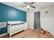 Stylish Bedroom with a white crib, rocking horse, and an accent wall at 2156 Doris Dr, Decatur, GA 30034