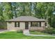 Charming one-story home with a light painted brick exterior, a cozy front porch, and a well-maintained landscaped yard at 2156 Doris Dr, Decatur, GA 30034