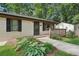 Close up exterior showing stone walkway, well kept grass and foliage, freshly painted brick and a cozy front porch at 2156 Doris Dr, Decatur, GA 30034
